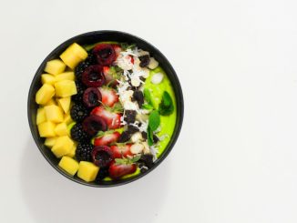 Delicious mixed fruit bowl with mango, blackberry, and cherry atop a creamy base. Perfect for a healthy diet.