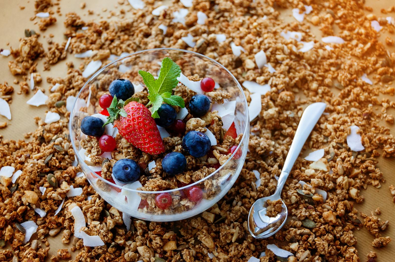 A top view of a healthy granola breakfast with fresh berries and yogurt in București.